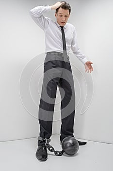 Businessman in shackles. Full length of shocked businessman look photo