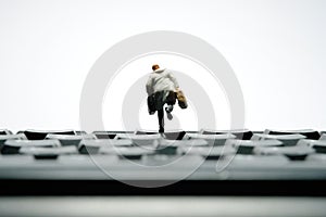 A businessman shadow silhouette running above keycaps keyboard carrying briefcase