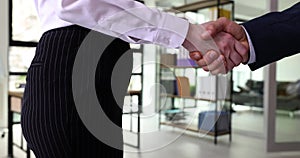 Businessman shaking hands with businesswoman client and agent and welcoming gesture