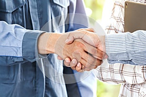 Businessman shaking hands with construction worker