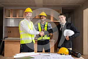 Businessman shaking hands with engineers in construction, construction site renovation concept, architect engineer