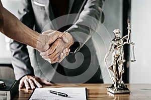 Businessman Shaking hands with lawyer after discussing good deal in courtroom