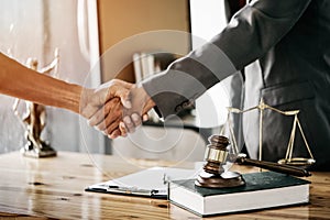 Businessman Shaking hands with lawyer after discussing good deal in courtroom