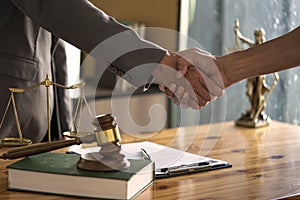 Businessman Shaking hands with lawyer after discussing good deal in courtroom