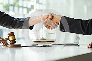 Businessman Shaking hands with lawyer after discussing good deal in courtroom