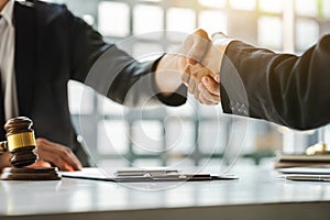 Businessman Shaking hands with lawyer after discussing good deal in courtroom