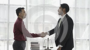 Businessman shaking hands with lawyer for lawyer wins court case and thanks for consulting law concept 4k