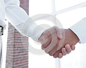 Closeup of a business handshake, on bright background