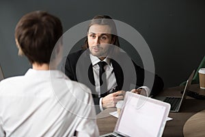 Businessman sharing business ideas with female partner during bo