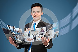Businessman sharing his photo and video files using laptop