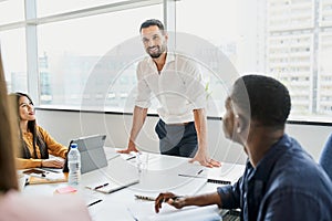 Businessman sharing ideas with team during business meeting