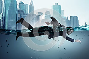 The businessman with shark fin swimming in water