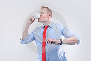 Businessman in a shirt with a red tie with cup of coffee ready for action. Bussines model poster concept