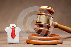 Businessman in shirt and tie and judge gavel on brown background. Concept of business sentence or condemnation of