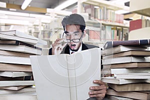 Businessman shock looking at book