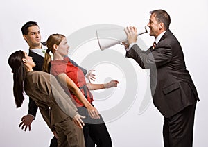 Businessman shouting at co-workers with megaphone