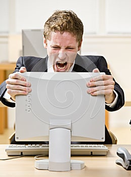 Businessman shouting at computer