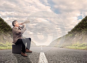 Businessman shouting with a megaphone