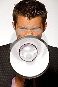 Businessman shouting through megaphone