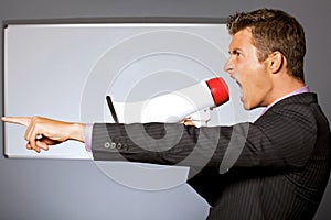 Businessman shouting through megaphone