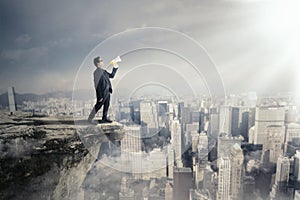 Businessman shouting with megaphone