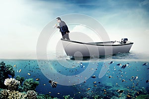 Businessman shouting with megaphone on boat