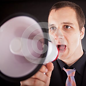 Businessman shouting through megaphone