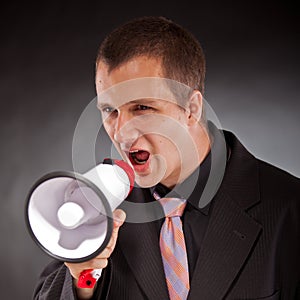 Businessman shouting through megaphone