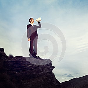 Businessman Shouting Megaphone Top Mountain Concept