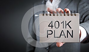 Businessman showing 401K Plan on notepad. Business