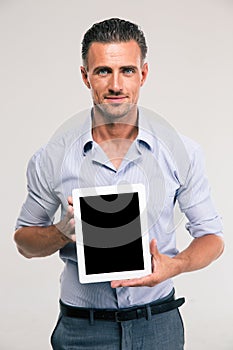 Businessman showing blank tablet computer screen