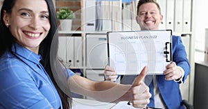 Businessman showing business plan for 2022 businesswoman smiling and holding thumb up slow motion 4k movie