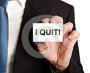 Businessman showing card with i quit sign