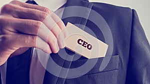 Businessman showing a card reading CEO