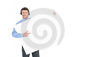 Businessman showing card wearing headset