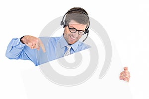 Businessman showing card wearing headset