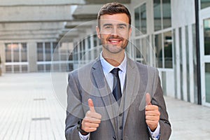 Businessman showing a double thumbs up