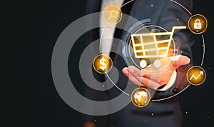 Businessman Showing E-Commerce concept with Shopping cart hovering above the hand, background with copy space. Online shopping