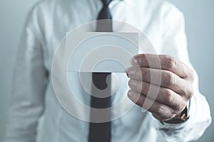 Businessman showing empty business card.