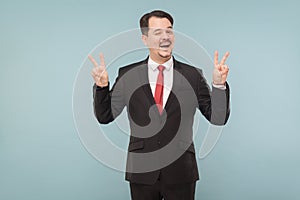 Businessman showing finger nomber four and wink