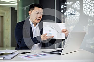 Businessman showing frustration during a video call in an office