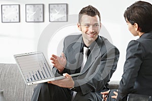 Businessman showing grapth on computer