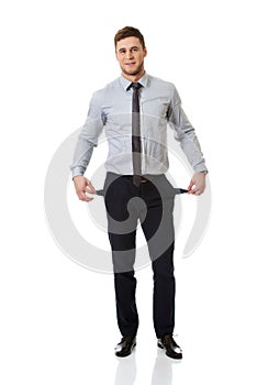 Businessman showing his empty pockets.
