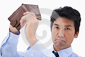 Businessman showing his empty wallet