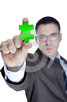 Businessman showing jigzaw puzzle piece