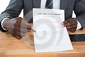 Businessman showing Last Will & Testament document