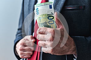 Businessman showing off with money, swagger entrepreneur holding bunch of hundred euro banknotes