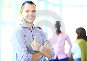 Businessman showing OK sign with his thumb up.