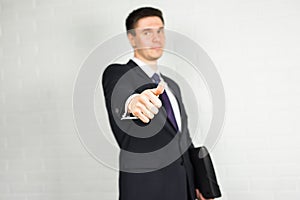 Businessman showing OK sign with his thumb up.