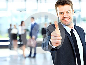 Businessman showing OK sign with his thumb